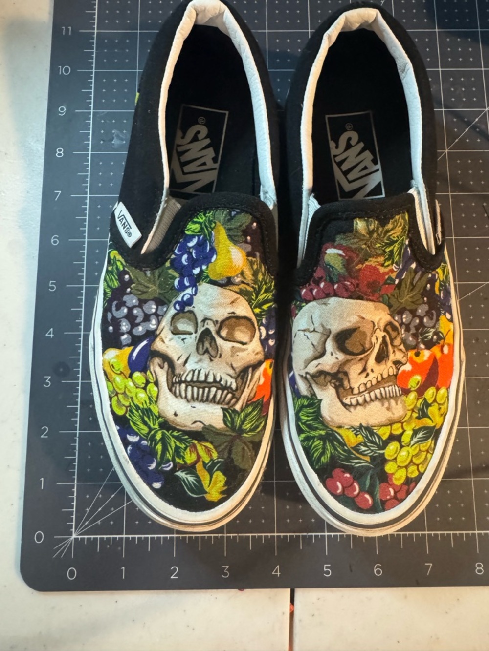 Vans Kids Black Slip-On Sneakers with Colorful Skull & Fruit Graphic